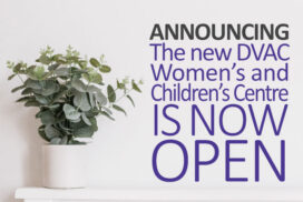 A plant in a white pot in front of a white wall with words in purple: Announcing the new DVAC Women’s and Children’s Centre is now open